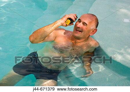 Man with waterproof phone inside a pool, smiling, Miramar, Florida, USA View Large Photo Image Stock Photo - Man with waterproof phone inside a pool, smiling, Miramar, Florida, USA. Fotosearch