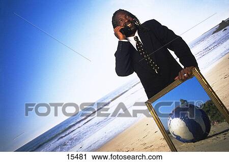 Stock Image - Man with world globe. Fotosearch