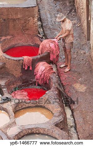 Stock Photo - man working in the tanner's quarter in Fes El Bali, Fes, Morocco. Fotosearch