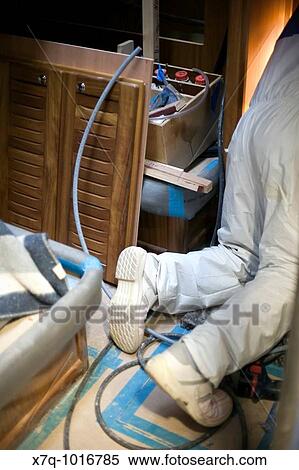 Man working inside yacht cabin in a shipyard View Large Photo Image Stock Photography - Man working inside yacht cabin in a shipyard. Fotosearch