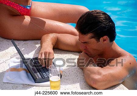 Man working with laptop computer in the pool View Large Photo Image Stock Image - Man working with laptop computer in the pool. Fotosearch
