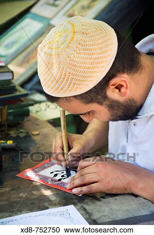 Stock Image - man writing in arabic. Fotosearch