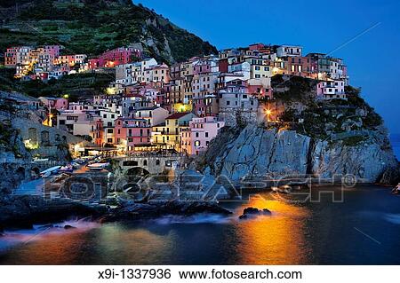 Manarola view at dusk across harbor with light reflection on water View Large Photo Image Stock Photograph - Manarola view at dusk across harbor with light reflection on water. Fotosearch