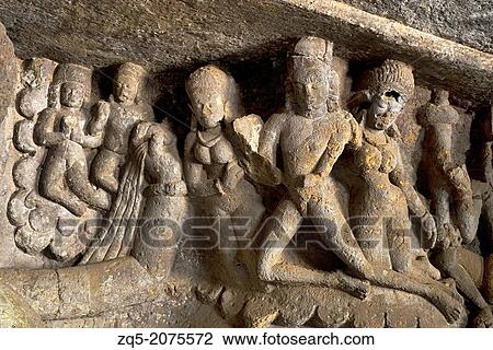 Stock Image - Mandapeshwar rock-cut cave, Mumbai. Dieties on viewer's upper right paying obisence to Lord Shiva. Borivali, Mumbai, Maharashtra, India.. Fotosearch