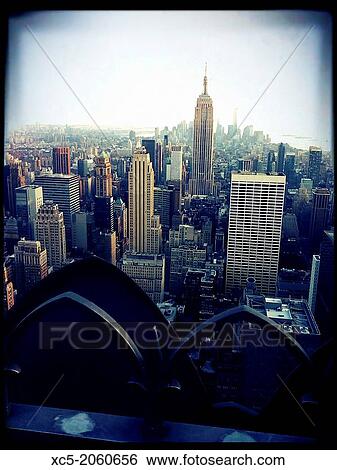 Stock Photograph - Manhattan Skyline from Top of the Rock, including Empire State Building, New York City.. Fotosearch