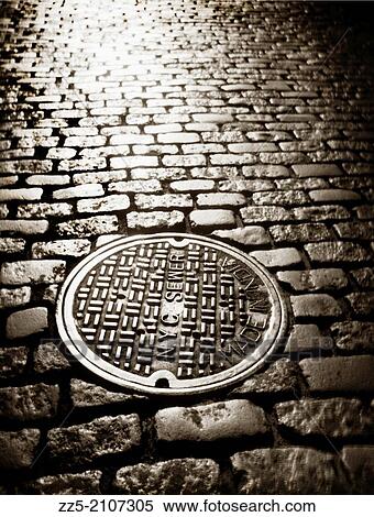 manhole cover cobblestone street. View Large Photo Image Stock Photography - manhole cover cobblestone street.. Fotosearch