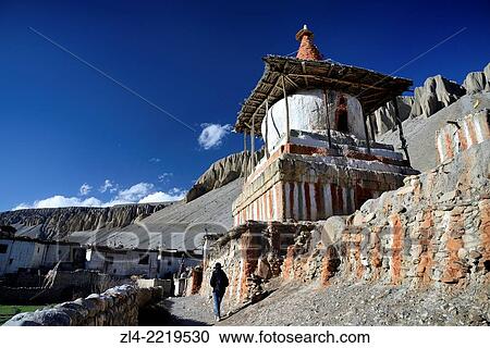 Mani wall (stones inscribed with a buddhist mantra) and stupa (chorten) in the village of Tangge. Nepal, Gandaki, Upper Mustang (near the border with Tibet). Model Released. View Large Photo Image Stock Image - Mani wall (stones inscribed with a buddhist mantra) and stupa (chorten) in the village of Tangge. Nepal, Gandaki, Upper Mustang (near the border with Tibet). Model Released.. Fotosearch