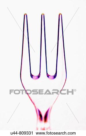 Stock Image - Maniplated color plastic transparent fork with colored edges. Fotosearch
