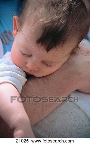 Man's arm holding sleeping baby facing front View Large Photo Image Stock Photography - Man's arm holding sleeping baby facing front. Fotosearch