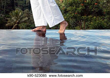 Man's feet on the edge of an outdoor pool at Losari Coffee Plantation in West Java, Indonesia, South East Asia View Large Photo Image Stock Photography - Man's feet on the edge of an outdoor pool at Losari Coffee Plantation in West Java, Indonesia, South East Asia. Fotosearch