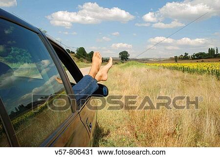 Man's feet sticking out of a car View Large Photo Image Stock Image - Man's feet sticking out of a car. Fotosearch