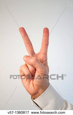Stock Photo - Man's hand expressing victory. Close view.. Fotosearch