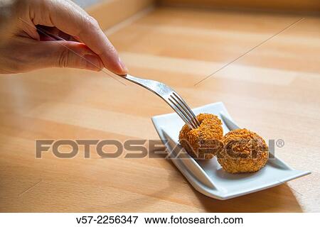 Man's hand having croquettes. Close view. View Large Photo Image Stock Photo - Man's hand having croquettes. Close view.. Fotosearch