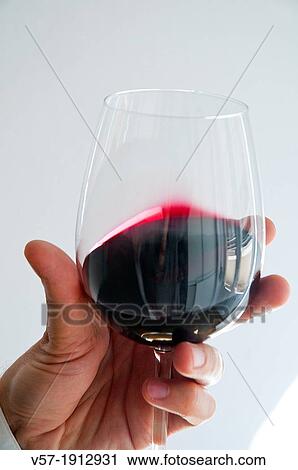 Man's hand holding a glass of red wine. Close view. View Large Photo Image Stock Image - Man's hand holding a glass of red wine. Close view.. Fotosearch