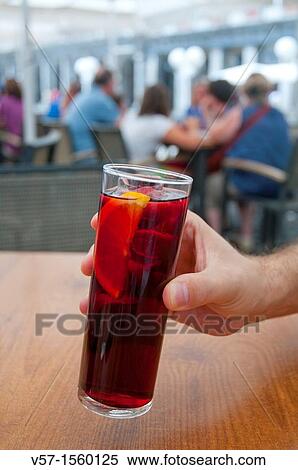 Man's hand holding a glass of sangria. Main Square, Madrid, Spain. View Large Photo Image Stock Photography - Man's hand holding a glass of sangria. Main Square, Madrid, Spain.. Fotosearch