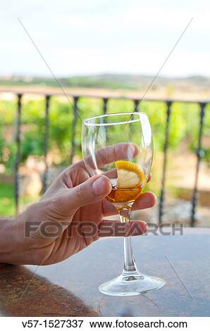 Man's hand holding an empty glass of liqueur. Close view. View Large Photo Image Stock Photo - Man's hand holding an empty glass of liqueur. Close view.. Fotosearch