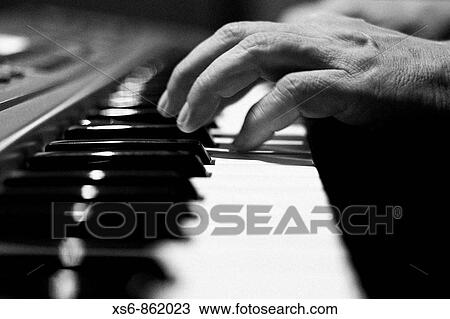 Man's hand playing the piano View Large Photo Image Stock Image - Man's hand playing the piano. Fotosearch