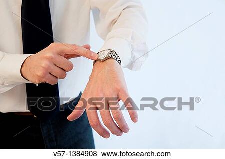 Man's hand pointing his watch. Close view. View Large Photo Image Stock Photo - Man's hand pointing his watch. Close view.. Fotosearch