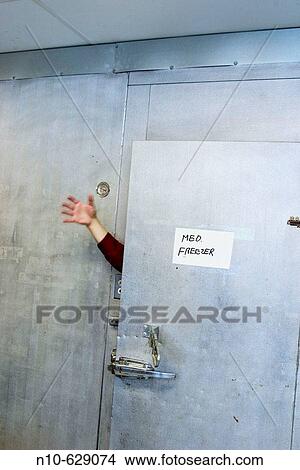 Man's hand sticking out through the open door of an industrial freezer. View Large Photo Image Picture - Man's hand sticking out through the open door of an industrial freezer.. Fotosearch