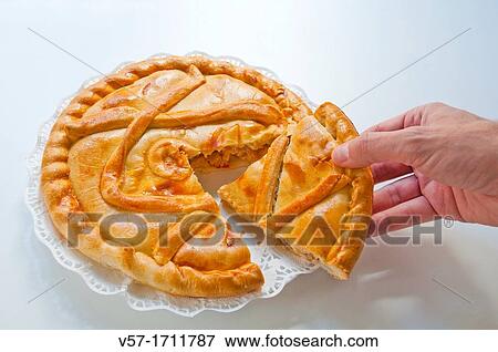 Man's hand taking a piece of Spanish empanada View Large Photo Image Stock Photo - Man's hand taking a piece of Spanish empanada. Fotosearch