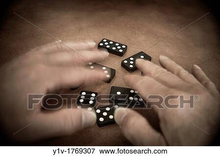 Man's hands playing with dominoes View Large Photo Image Stock Photo - Man's hands playing with dominoes. Fotosearch