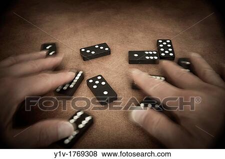 Man's hands playing with dominoes View Large Photo Image Stock Photo - Man's hands playing with dominoes. Fotosearch