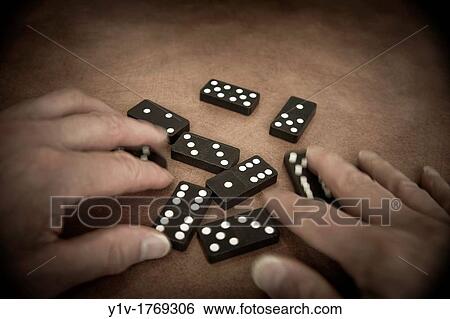 Man's hands playing with dominoes View Large Photo Image Stock Photograph - Man's hands playing with dominoes. Fotosearch