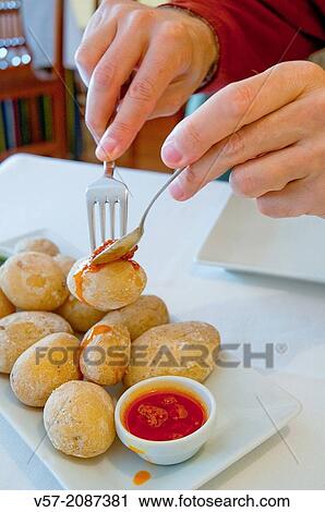 Man's hands serving himself papas arrugadas with red mojo sauce in a Canarian restaurant. Canary Islands, Spain. View Large Photo Image Stock Image - Man's hands serving himself papas arrugadas with red mojo sauce in a Canarian restaurant. Canary Islands, Spain.. Fotosearch