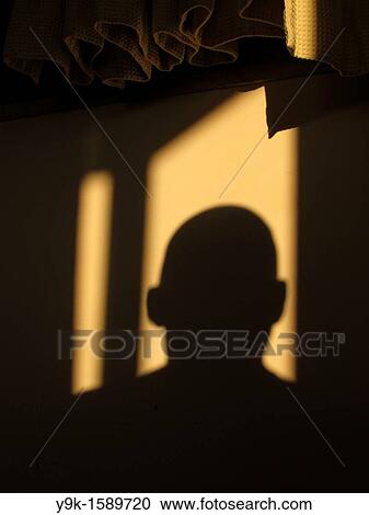 Man's head shadow on room wall with curtains View Large Photo Image Stock Image - Man's head shadow on room wall with curtains. Fotosearch