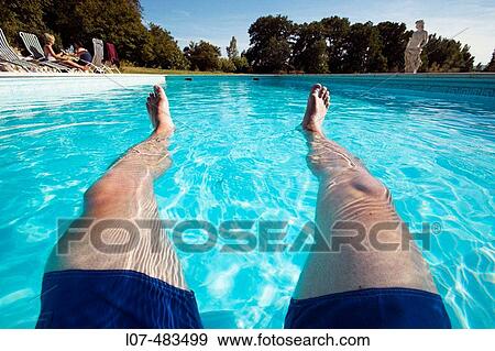 Man's outstretched feet in a swimming pool. France View Large Photo Image Stock Photo - Man's outstretched feet in a swimming pool. France. Fotosearch