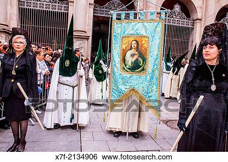 Stock Photograph - `Mantillas? e??and Hooded penitents in procession, sisterhood of Jess del Gran Poder y virgen de la Macarena, Good Friday, Easter week, Plaza de San Agustin, Barcelona, Catalonia, Spain.. Fotosearch