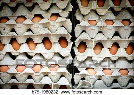 Stock Image - Many eggs in egg cartons stacked. Fotosearch