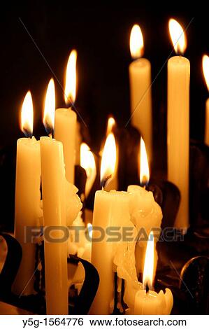 many lit candles in dark room in church View Large Photo Image Stock Photograph - many lit candles in dark room in church. Fotosearch