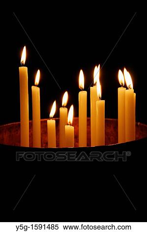 many lit candles in dark room in church View Large Photo Image Stock Photography - many lit candles in dark room in church. Fotosearch