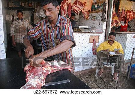 Stock Image - Mapusa Goa, India: butcher at the market. Fotosearch