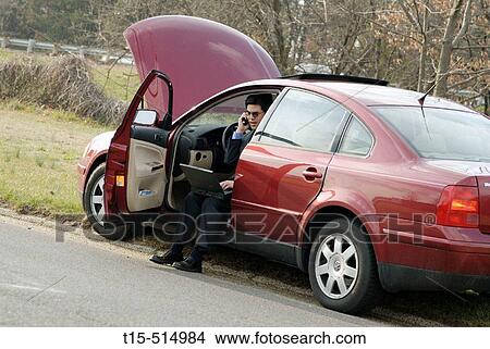 Mar broke down roadside, man using wireless internet connection to get towing service View Large Photo Image Picture - Mar broke down roadside, man using wireless internet connection to get towing service. Fotosearch