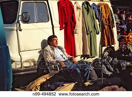 Stock Image - March? Aligre, clothes seller. Paris. France. Fotosearch