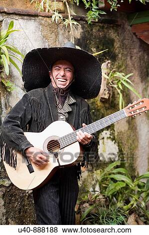 Stock Photo - Mariachi playing guitar and singing. Fotosearch