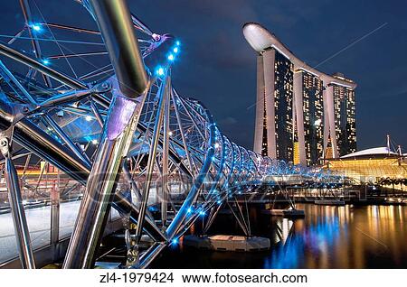 Picture - Marina Bay Sands hotel designed by the architect Moshe Safdie in the evening, viewed from the Helix bridge. Singapore, Marina Bay.. Fotosearch