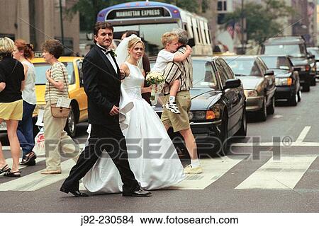 Picture - Married couple crossing Fifth Avenue in Manhattan. New York. US.. Fotosearch
