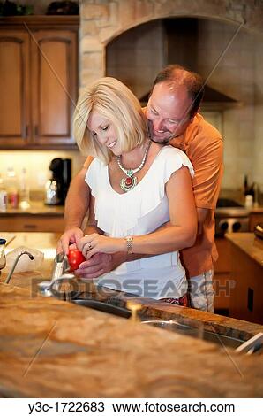 Married couple in the kitchen of their nice home View Large Photo Image Stock Image - Married couple in the kitchen of their nice home. Fotosearch