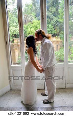 Married couple kissing in front of a window View Large Photo Image Stock Image - Married couple kissing in front of a window. Fotosearch
