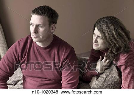 Married couple sitting on their bed View Large Photo Image Stock Photo - Married couple sitting on their bed. Fotosearch