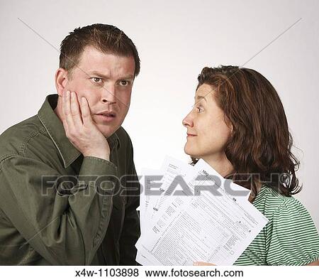 Married couple with United States 1040 tax forms feeling anxious about their taxes View Large Photo Image Stock Photo - Married couple with United States 1040 tax forms feeling anxious about their taxes. Fotosearch