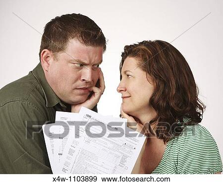 Married couple with United States 1040 tax forms feeling anxious about their taxes View Large Photo Image Stock Photo - Married couple with United States 1040 tax forms feeling anxious about their taxes. Fotosearch