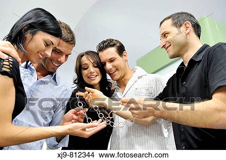 Married couples watching a necklace in jewelry. View Large Photo Image Picture - Married couples watching a necklace in jewelry.. Fotosearch