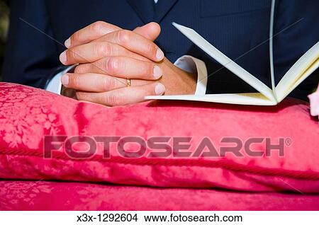 Married man absorbed in prayer in church View Large Photo Image Picture - Married man absorbed in prayer in church. Fotosearch