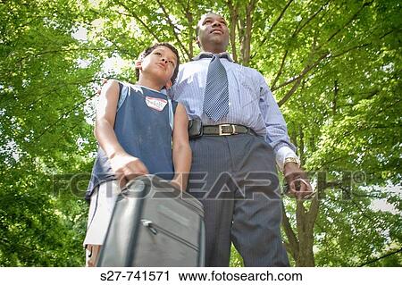 Marvin picks up his son Christian, 9, from a summer day camp View Large Photo Image Stock Image - Marvin picks up his son Christian, 9, from a summer day camp. Fotosearch