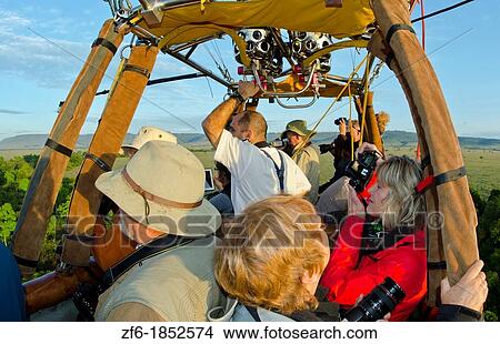 Masai Mara National Park Kenya Africa balloon ride for tourists early morning in Masai Mara people in basket together with balloon View Large Photo Image Picture - Masai Mara National Park Kenya Africa balloon ride for tourists early morning in Masai Mara people in basket together with balloon. Fotosearch