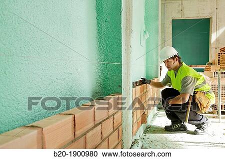 Mason checking the level of a brick wall, Bricklayer with personal protective equipment, PPE, Apartment Building under construction, Donostia, San Sebastian, Gipuzkoa, Basque Country, Spain View Large Photo Image Stock Image - Mason checking the level of a brick wall, Bricklayer with personal protective equipment, PPE, Apartment Building under construction, Donostia, San Sebastian, Gipuzkoa, Basque Country, Spain. Fotosearch